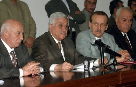 Mahmoud Abbas (2L), then acting chairman of the PLO executive committee, talks to journalists as Ahmed Qurie (L), then prime minister of the Palestinian Authority, Yasser Abed Rabbo (2R), then member of the PLO executive committee, and Tayeb Abdel Rahim (R), advisor to Palestinian leader Yasser Arafat, look on during a news conference after a meeting in the West Bank town of Ramallah, in this October 30, 2004 file photo. REUTERS/Loay Abu Haykel/Files