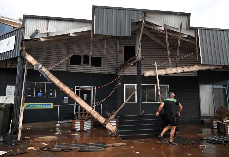 LISMORE, AUSTRALIA - MARCH 02:  Grant McPherson removes debris from his flood-affected car mechanic business on March 02, 2022 in Lismore, Australia. Several northern New South Wales towns have been forced to evacuate as Australia faces unprecedented storms and the worst flooding in a decade. (Photo by Dan Peled/Getty Images)