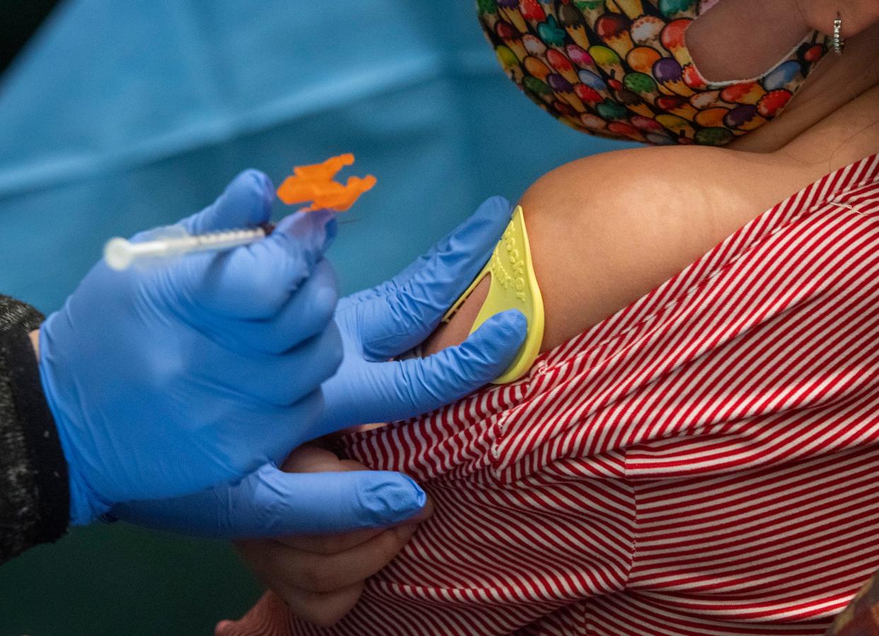 In a file photo, a child receives a COVID-19 vaccination shot during an open vaccination clinic in Worcester.