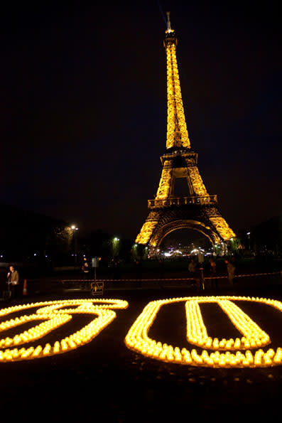 Earth Hour 2010. Candles forming 60 for Earth Hour near the Eiffel Tour, Paris, France. <br> <a href="http://www.worldwildlife.org/sites/earthhour/index.html" rel="nofollow noopener" target="_blank" data-ylk="slk:For more information about Earth Hour 2012, visit WWF.;elm:context_link;itc:0;sec:content-canvas" class="link ">For more information about Earth Hour 2012, visit WWF.</a>