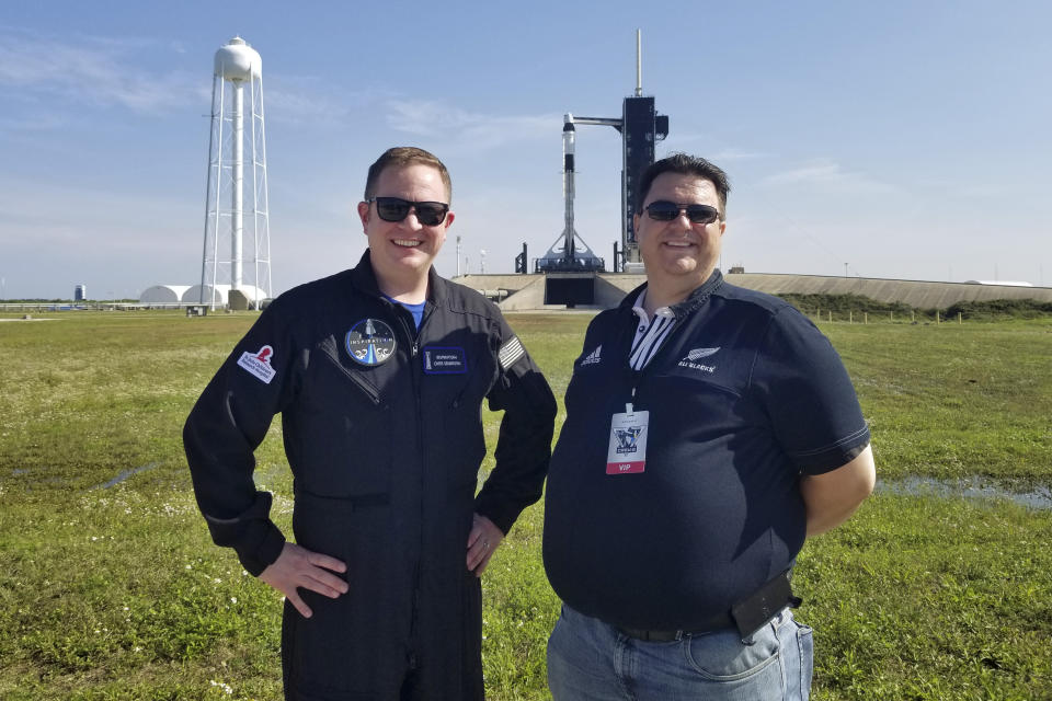 This photo provided by Kyle Hippchen shows him, right, with Chris Sembroski near launch complex 39A in Cape Canaveral, Fla., on April 21, 2021. Hippchen says Sembroski is the one person “who lives and breathes” space stuff like he does. (Courtesy Kyle Hippchen via AP)