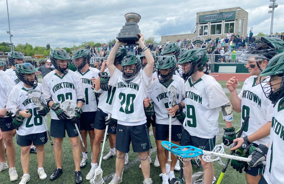 Yorktown players celebrate with the Murphy Cup after defeating Lakeland-Panas 7-5 in the annual Murphy Cup game at Yorktown High School May 11, 2024.