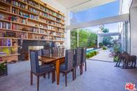 <p>The living room also features a beautiful dining area that looks out into the modern yard. (Zillow) </p>
