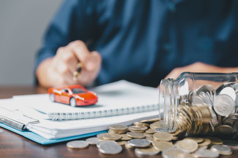 Car toy vehicle with stack coin money on background