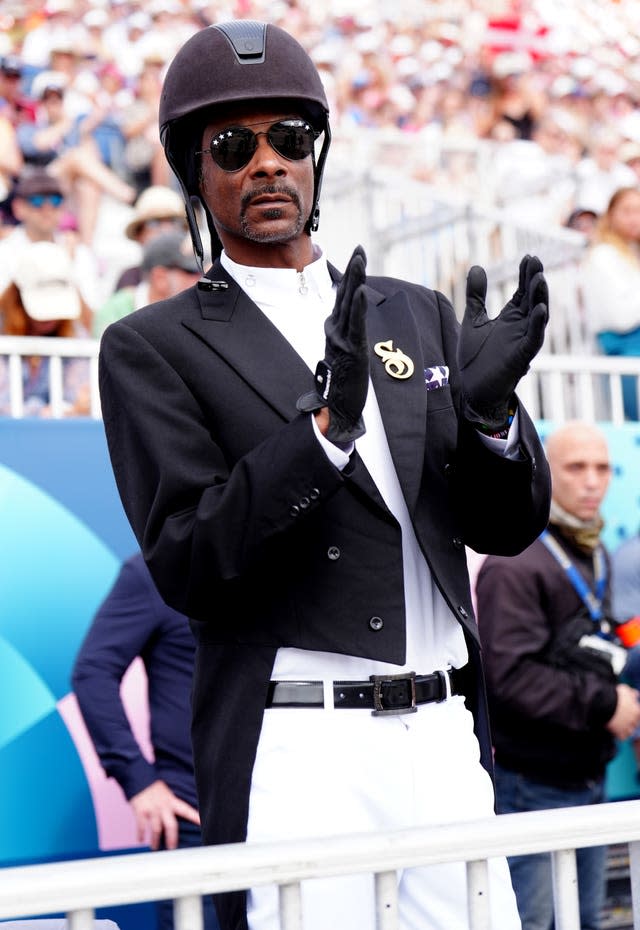 Snoop Dogg watching the dressage in equestrian gear