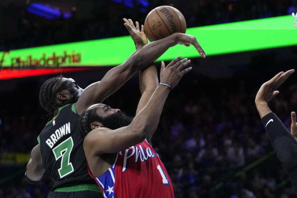 Philadelphia 76ers' James Harden (1) goes up to shoot against Boston Celtics' Jaylen Brown (7) during the first half of Game 3 in an NBA basketball Eastern Conference semifinals playoff series, Friday, May 5, 2023, in Philadelphia. (AP Photo/Matt Slocum)