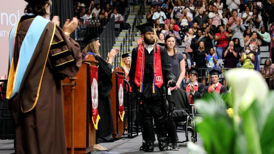 With the help of Ekso Bionics’ robotic exoskeleton, Khalil Watson rose from his wheelchair and walked across the stage to receive his associate’s degree from Reynolds Community College.