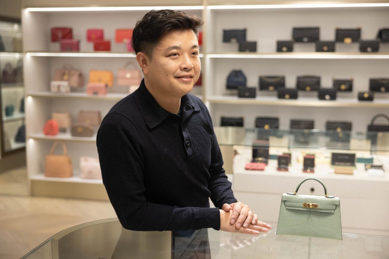 <span>Owner Alex Leung at The Purse Affair in Melbourne, which specialises in secondhand high-end bags.</span><span>Photograph: Ellen Smith/The Guardian</span>