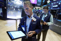 Trader Robert Charmak, left, works on the floor of the New York Stock Exchange, Friday, Aug. 25, 2023. (AP Photo/Richard Drew)