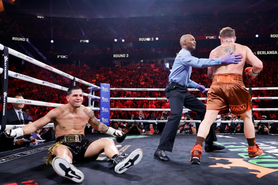 LAS VEGAS, NEVADA - SEPTEMBER 14: Edgar Berlanga sits on the canvas as referee Harvey Dock leads WBC/WBA/WBO super middleweight champion Canelo Alvarez to a neutral corner during the third round of a title fight at T-Mobile Arena on September 14, 2024 in Las Vegas, Nevada. (Photo by Steve Marcus/Getty Images)