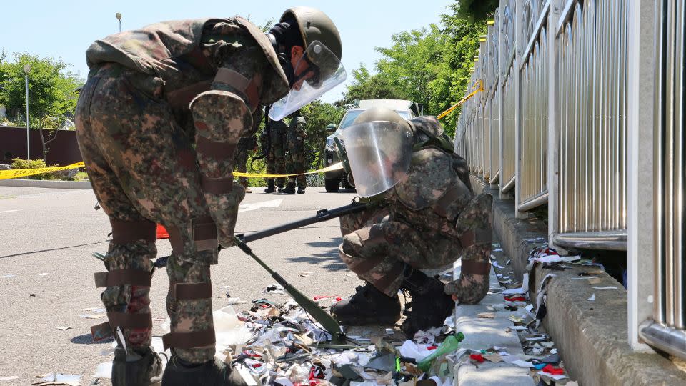 Soldiers inspect debris from a balloon sent by North Korea that landed in Incheon, South Korea. - Im Sun-suk/Yonhap/AP