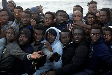 Sub-Saharan migrants are seen aboard an overcrowded raft during a rescue operation by the Spanish NGO Proactiva Open Arms in the central Mediterranean Sea, 21 miles north of the coastal Libyan city of Sabratha, February 3, 2017. REUTERS/Giorgos Moutafis