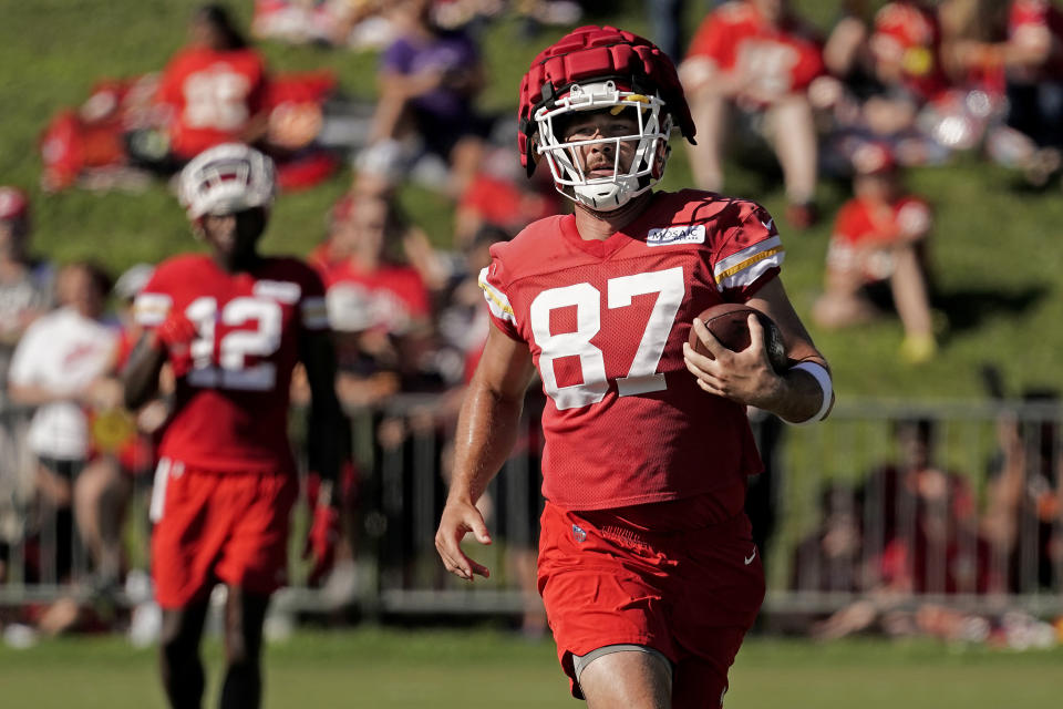 Kansas City Chiefs tight end Travis Kelce runs the ball at NFL football training camp Saturday, July 30, 2022, in St. Joseph, Mo. (AP Photo/Charlie Riedel)