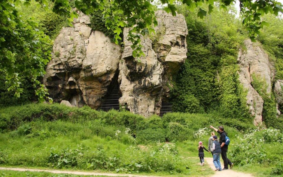 Visitors pass caves in Creswell Crags, a limestone valley on the border of Derbyshire and Nottinghamshire