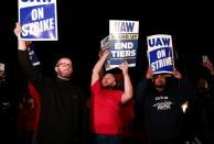 United Auto Workers hold up strike signs right across from the Ford Michigan Assembly Plant in Wayne