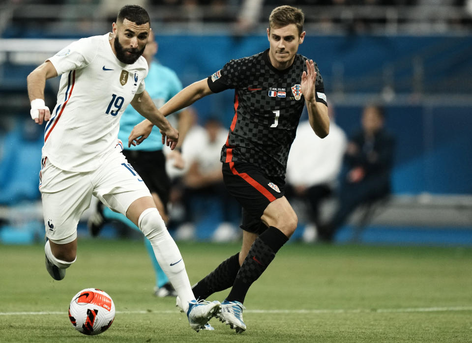 FILE - France's Karim Benzema, left, duels for the ball with Croatia's Josip Stanisic during the UEFA Nations League soccer match between France and Croatia at the Stade de France in Saint Denis near Paris, Monday, June 13, 2022. (AP Photo/Thibault Camus, File)