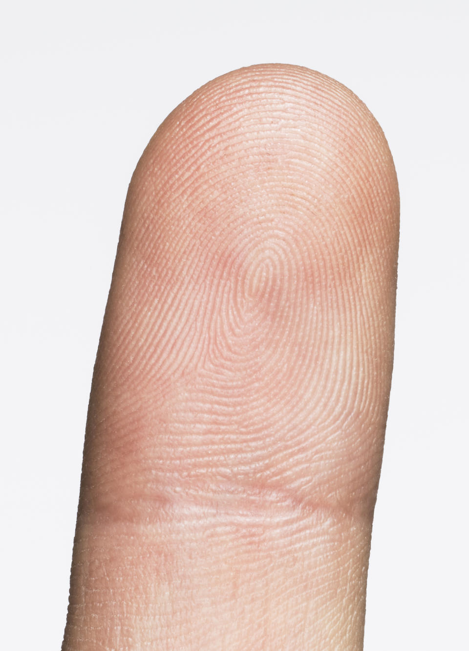 Close-up image of a fingertip with a clear view of the fingerprint pattern