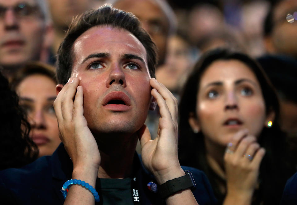 A man reacts as he watches voting results at Democratic presidential nominee former Secretary of State Hillary Clinton's election night event.