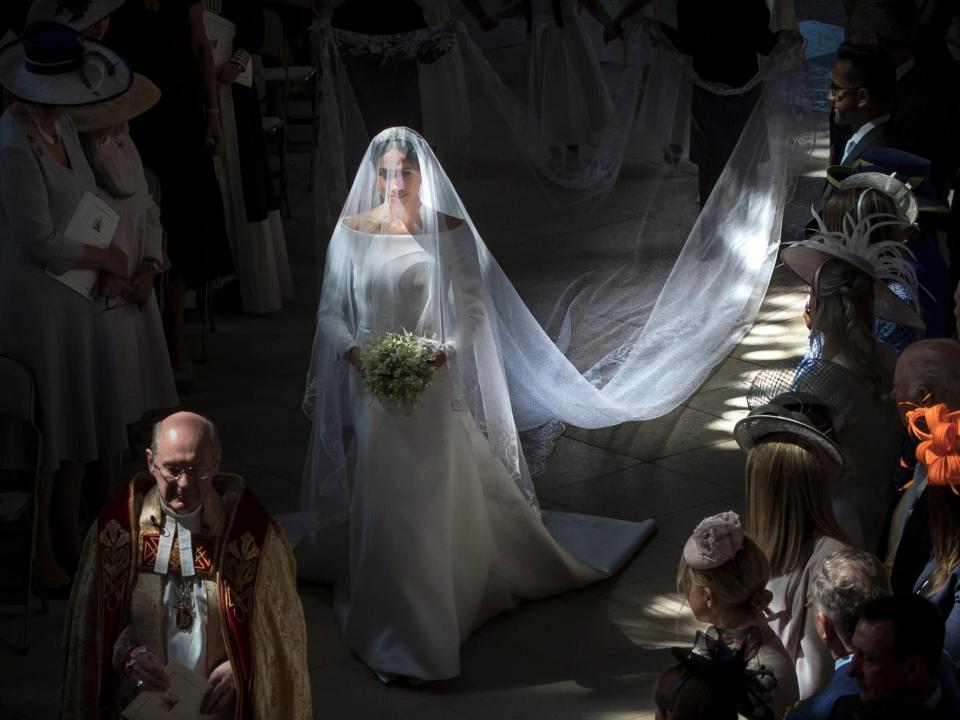 Meghan Markle walks down the aisle at her wedding, unaccompanied.