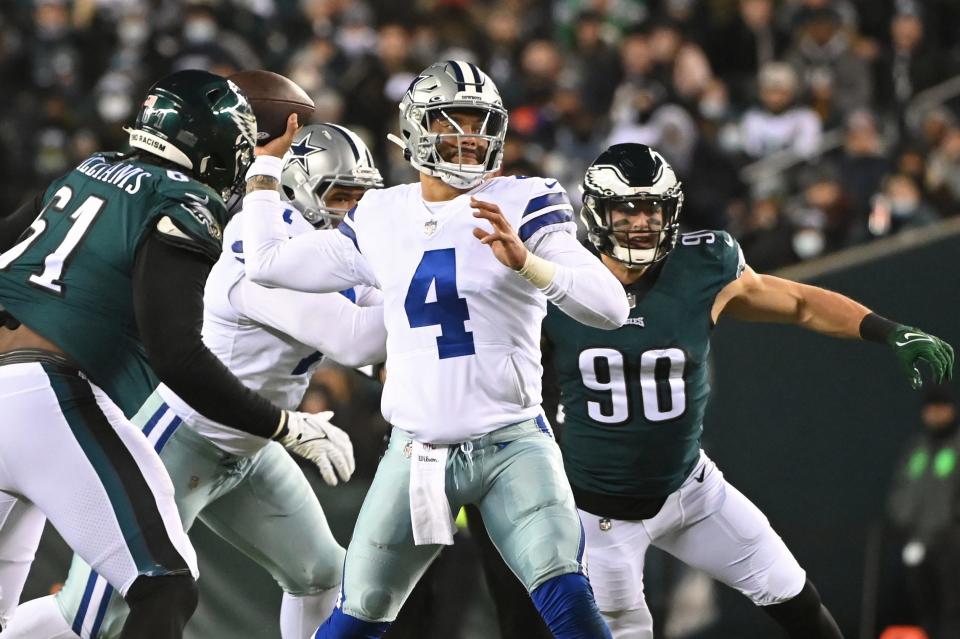 Dallas Cowboys quarterback Dak Prescott (4) passes the ball under pressure from Philadelphia Eagles defensive tackle Raequan Williams (61) and Eagles defensive end Ryan Kerrigan (90).