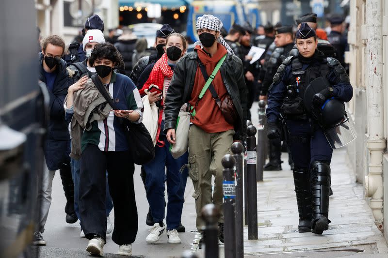 Protesters in support of Palestinians in Gaza are escorted away by police forces during the evacuation of the Sciences Po University, in Paris