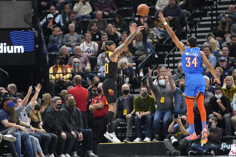 Utah Jazz guard Jordan Clarkson (00) shoots as Oklahoma City Thunder forward Kenrich Williams (34) defends during the first half of an NBA basketball game Wednesday, Oct. 20, 2021, in Salt Lake City. (AP Photo/Rick Bowmer)