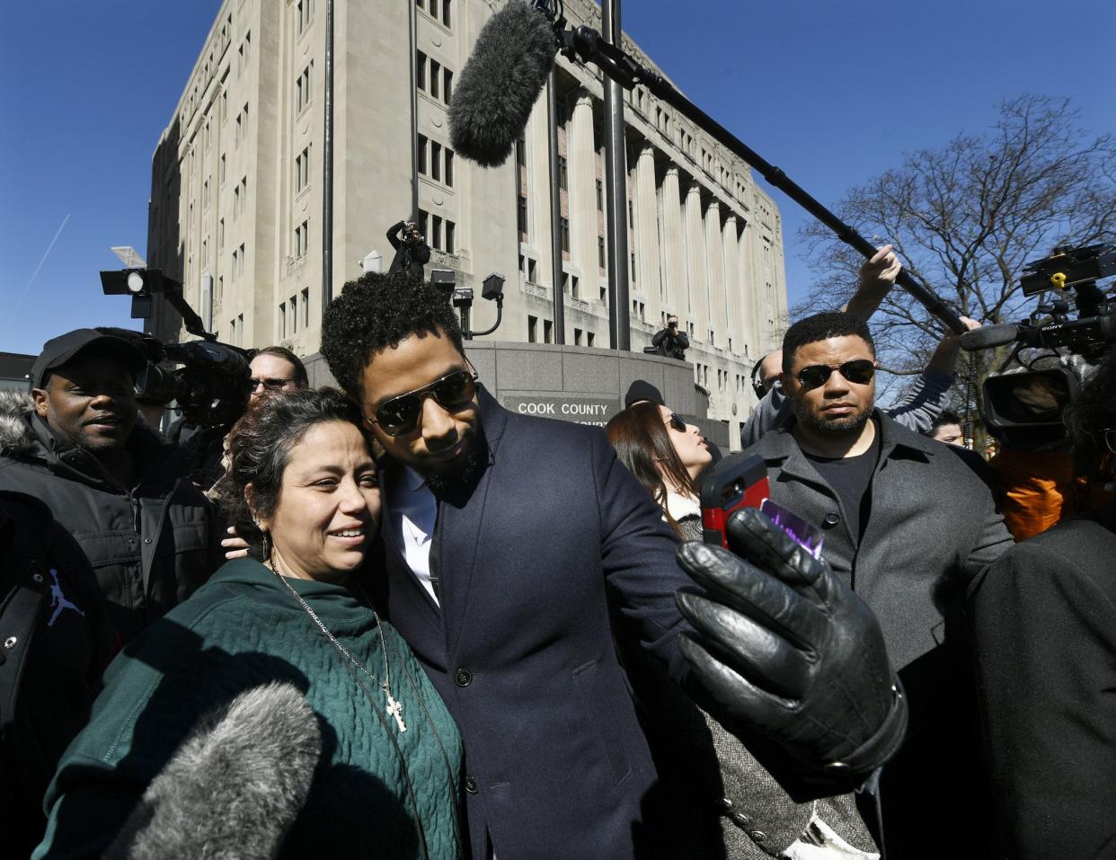 Actor Jussie Smollett takes a selfie with a fan while leaving Cook County Court after his charges were dropped Tuesday, March 26, 2019, in Chicago. Smollett was indicted on 16 felony counts related to making a false report that he was attacked by two men who shouted racial and homophobic slurs.