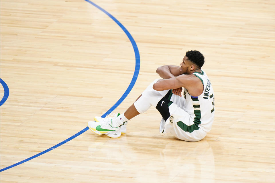 Milwaukee Bucks' Giannis Antetokounmpo reacts after making a basket during overtime in an NBA basketball game against the Philadelphia 76ers, Wednesday, March 17, 2021, in Philadelphia. (AP Photo/Matt Slocum)