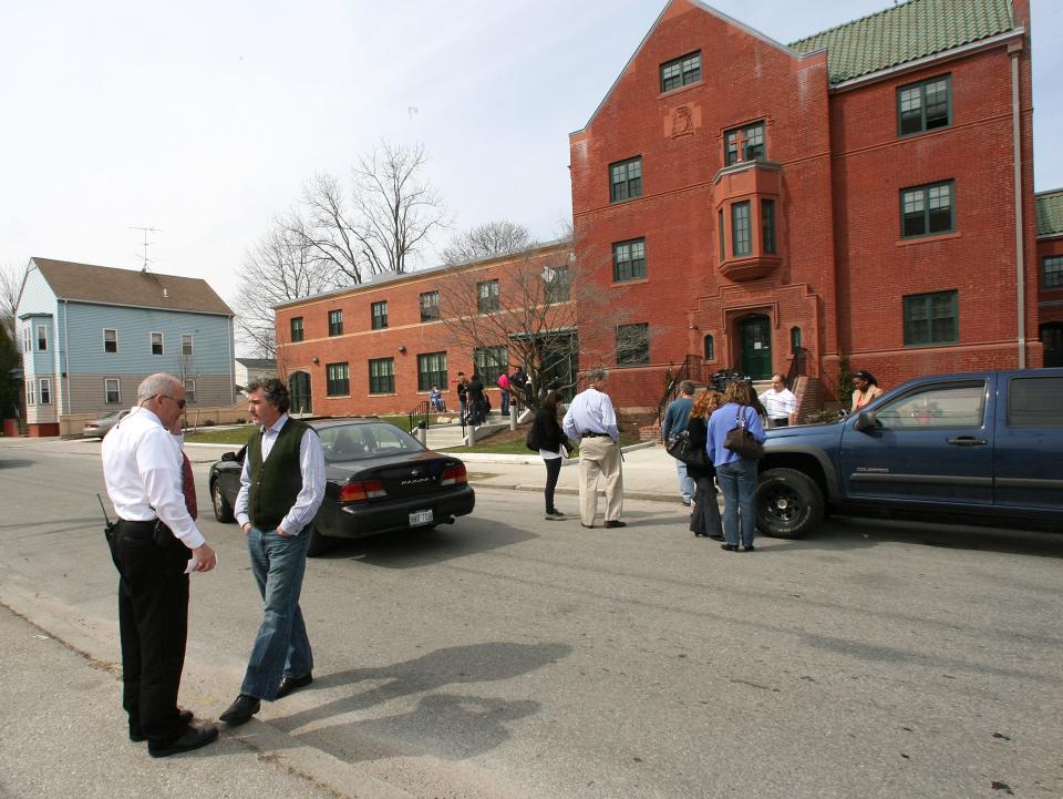 Providence police Lt. Paul Campbell talks with Teny Gross, director of the Institute for the Study and Practice of Nonviolence, after two men were shot as they sat in a parked car outside the institute on Oxford Street in 2011.