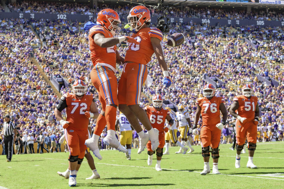 Florida running back Dameon Pierce (27) celebrates running back Malik Davis (20) after catching a touchdown pass in the second half of an NCAA college football game against LSU in Baton Rouge, La., Saturday, Oct. 16, 2021. (AP Photo/Matthew Hinton)