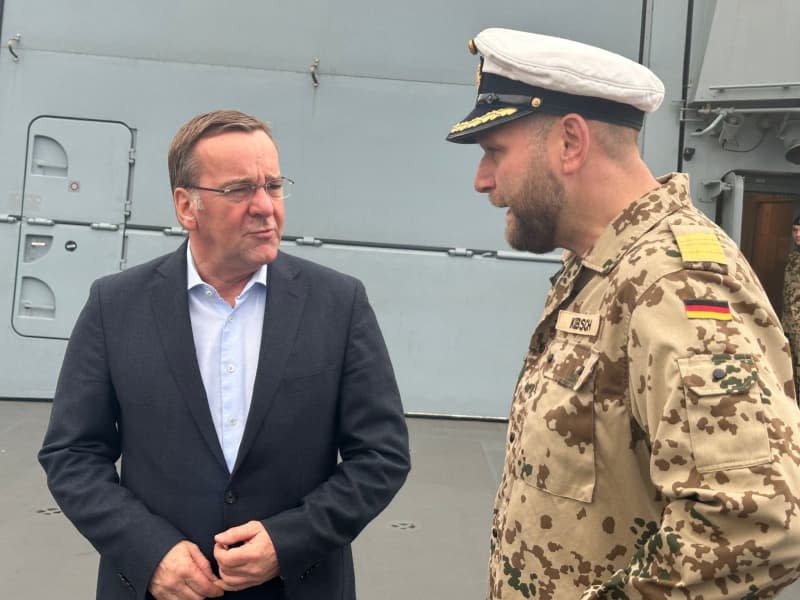 Boris Pistorius (L), German Minister of Defense, and the commander, frigate captain Volker Kuebsch, stand on board the frigate "Hessen" in Souda Bay, Crete. Shortly before the dangerous deployment of the frigate "Hessen" in the Red Sea, Defence Minister Pistorius will visit the 240 soldiers on board on Tuesday. The minister flew to Crete on Monday evening, where the 143-metre-long warship is currently making a stopover on its way from Wilhelmshaven to the deployment area. Michael Fischer/dpa