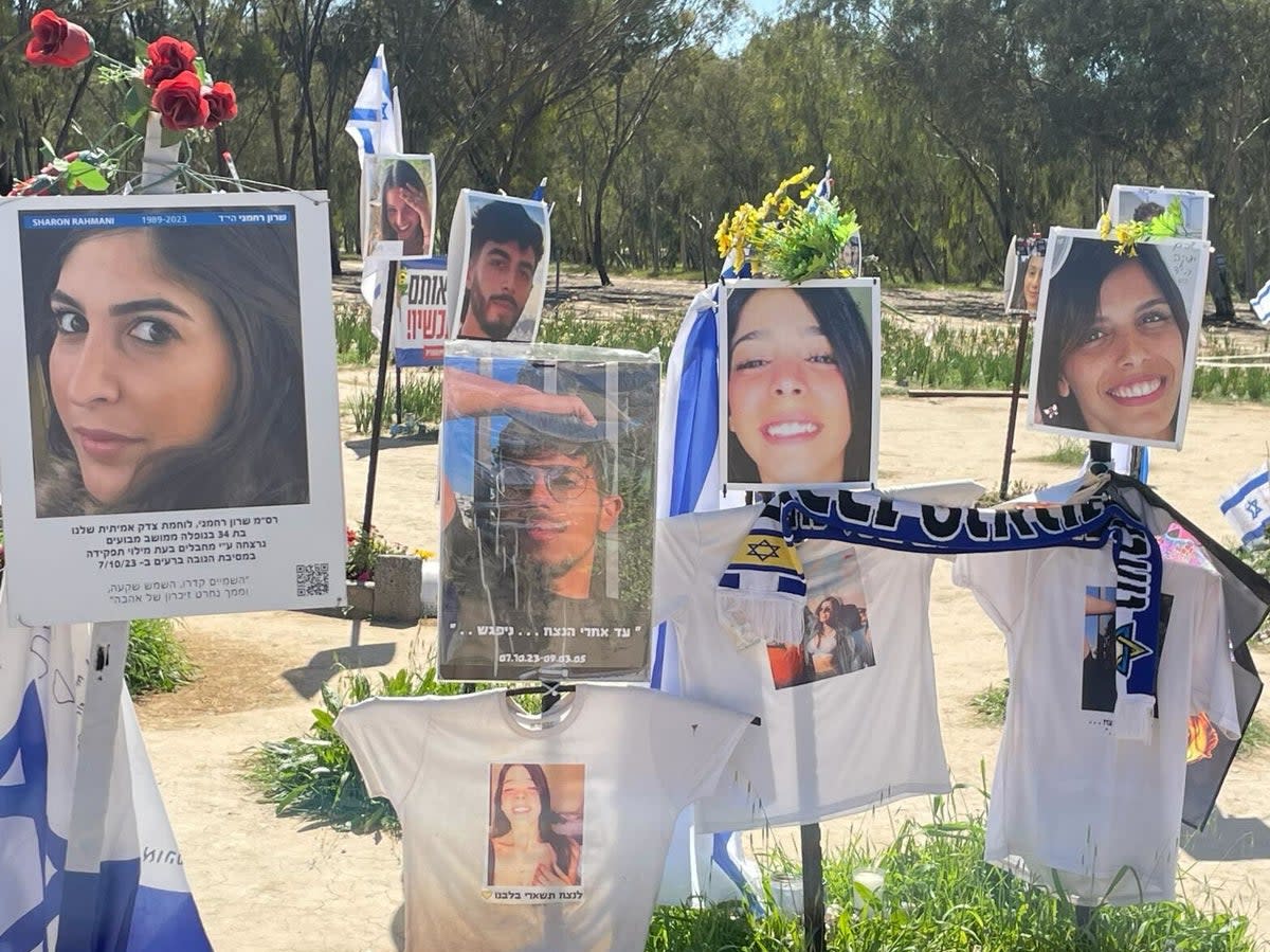 Paying tribute to some of those killed or kidnapped in the Hamas attack in Kfar Aza (Kim Sengupta/The Independent)