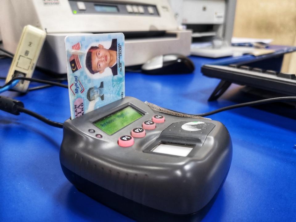 A MyKad identification card reader in use at a POS Malaysia outlet in Bangi October 15, 2018. — Picture by Shafwan Zaidon