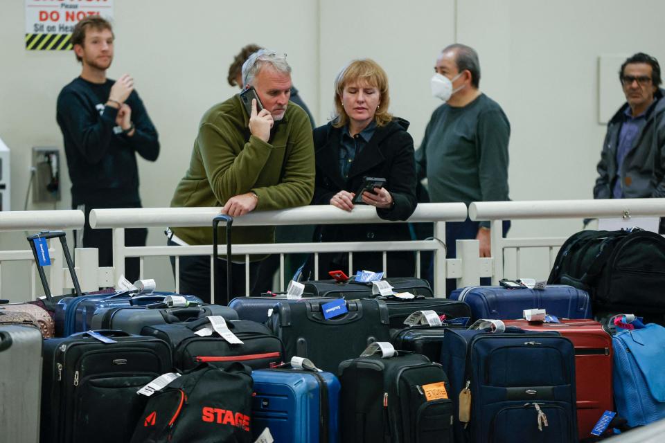 Stranded Southwest Airlines passengers look for their luggage in the baggage claim area at Chicago Midway International Airport on Dec. 28, 2022.