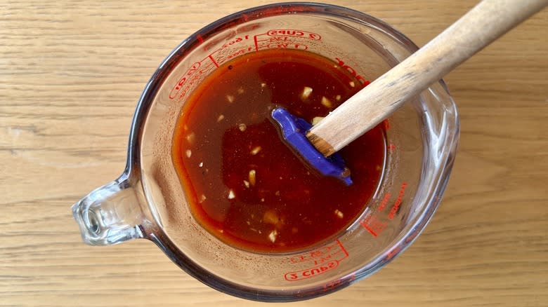 stirring marinade ingredients in cup