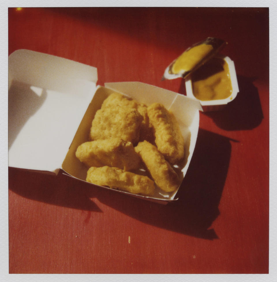 A pack of chicken nuggets with dipping sauce