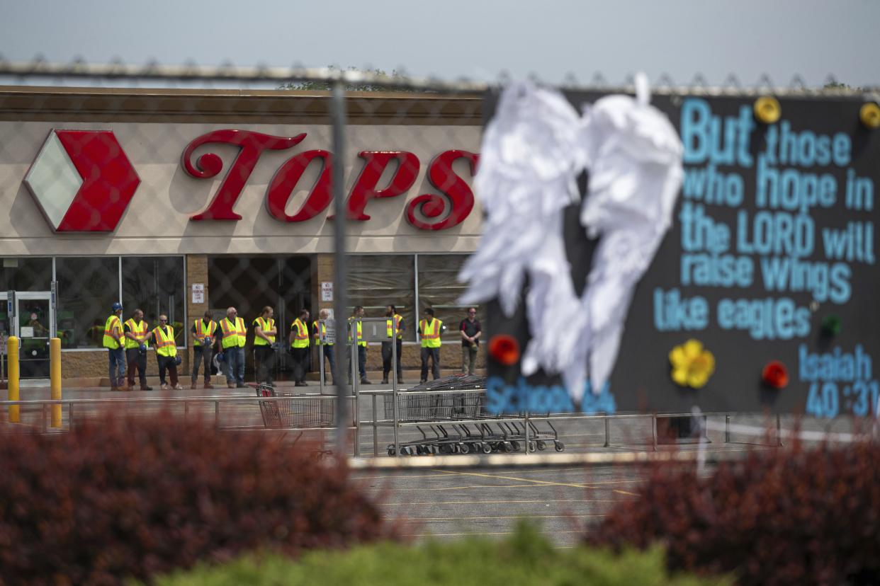 Investigators stand during a moment of silence for the victims of the Buffalo supermarket shooting outside the Tops Friendly Market on Saturday, May 21, 2022, in Buffalo, N.Y.