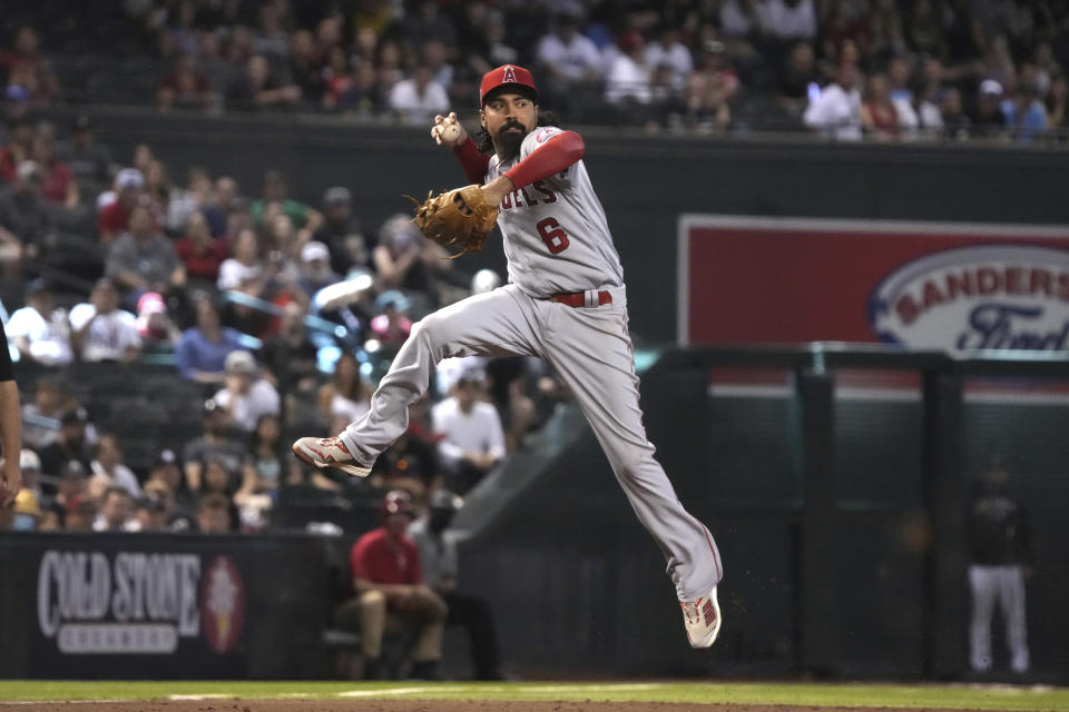 Los Angeles Angels third baseman Anthony Rendon makes the off balance throw on a ball hit by Arizona Diamondbacks' Josh Reddick in the third inning during a baseball game, Saturday, June 12, 2021, in Phoenix. (AP Photo/Rick Scuteri)