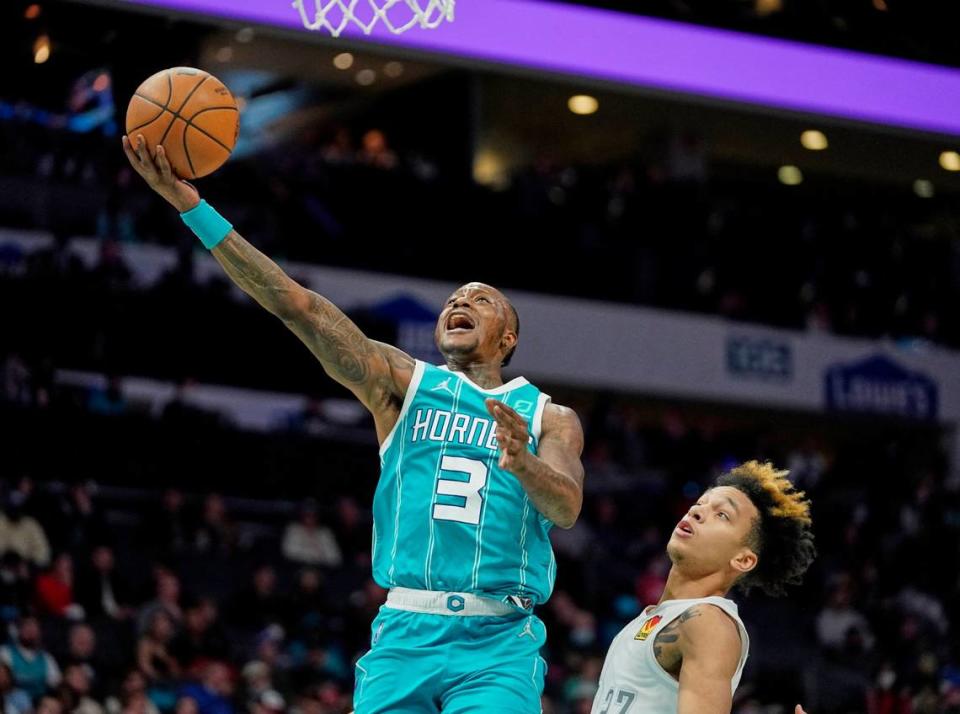 Charlotte Hornets guard Terry Rozier (3) makes a layup past Oklahoma City Thunder guard Tre Mann (23) during an NBA basketball game on Friday, Jan. 21, 2022, in Charlotte, N.C. Rozier scored 24 points as the Hornets won, 121-98.