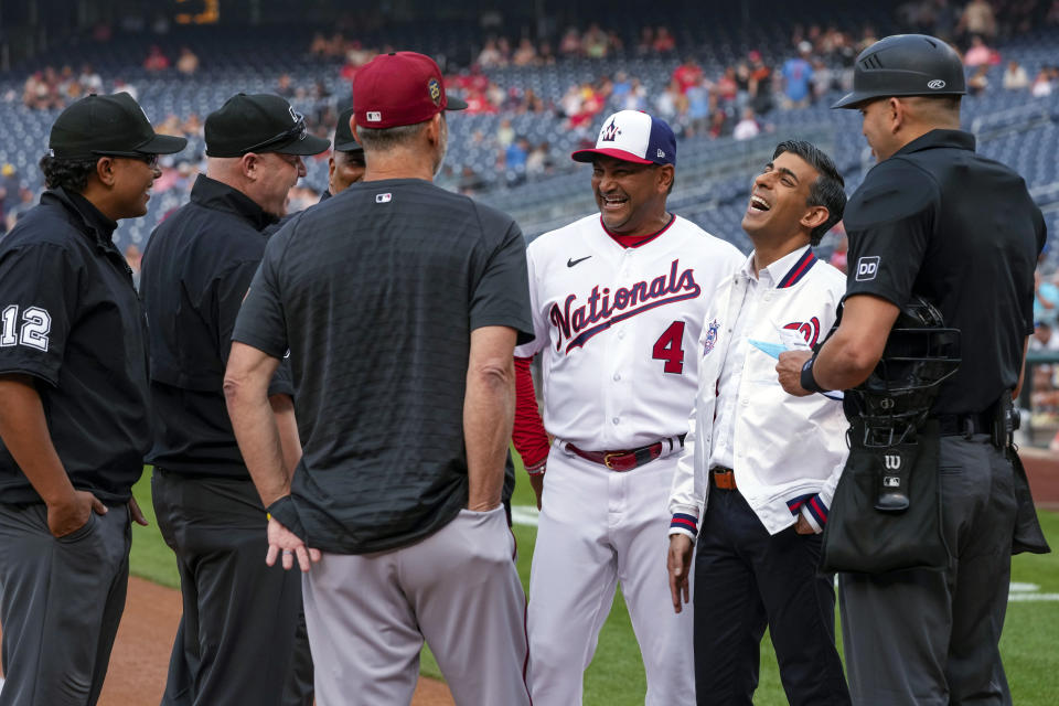 Washington Nationals manager Dave Martinez (4) and British Prime Minister Rishi Sunak, second from right, share a laugh with the umpires before a baseball game between the Washington Nationals and the Arizona Diamondbacks, at Nationals Park, Wednesday, June 7, 2023, in Washington. In celebration of the recent coronation of King Charles III and the enduring partnership between the United States and United Kingdom, the Washington Nationals are having "UK-US Friendship Day."(AP Photo/Alex Brandon)