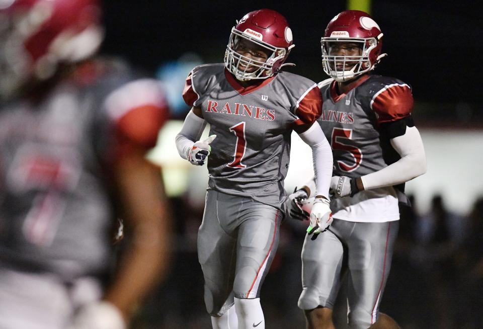 Raines cornerback Nicholas Kilpatrick (1) and teammate Jaylen Clark (5) run to the team's sideline after Kilpatrick's interception against Jackson.