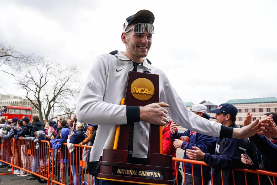 UConn Huskies center Donovan Clingan (32) holds the NCAA championship trophy while being greeted by fans before team’s victory parade April 13, 2024, in Hartford, Connecticut.