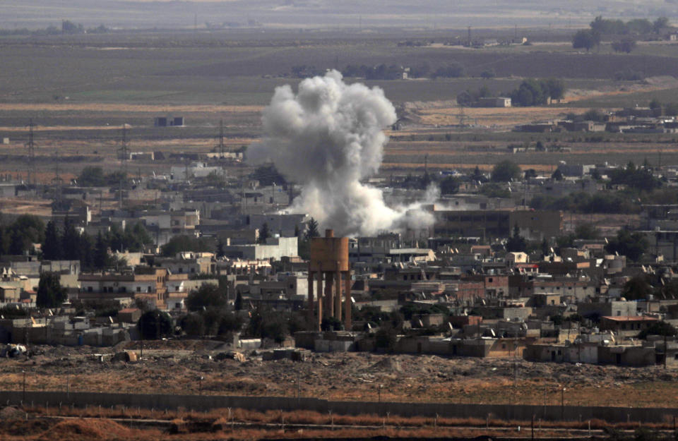 In this photo taken from the Turkish side of the border between Turkey and Syria, in Ceylanpinar, Sanliurfa province, southeastern Turkey, smoke and dust billows from targets in Ras al-Ayn, Syria, caused by bombardment by Turkish forces, Tuesday, Oct. 15, 2019. Turkish artillery on Tuesday pounded suspected Syrian Kurdish positions near the town in northeast Syria amid reports that Kurdish fighters had retaken the town as Turkey pressed ahead with a military incursion that has drawn widespread condemnation. (AP Photo/Lefteris Pitarakis)