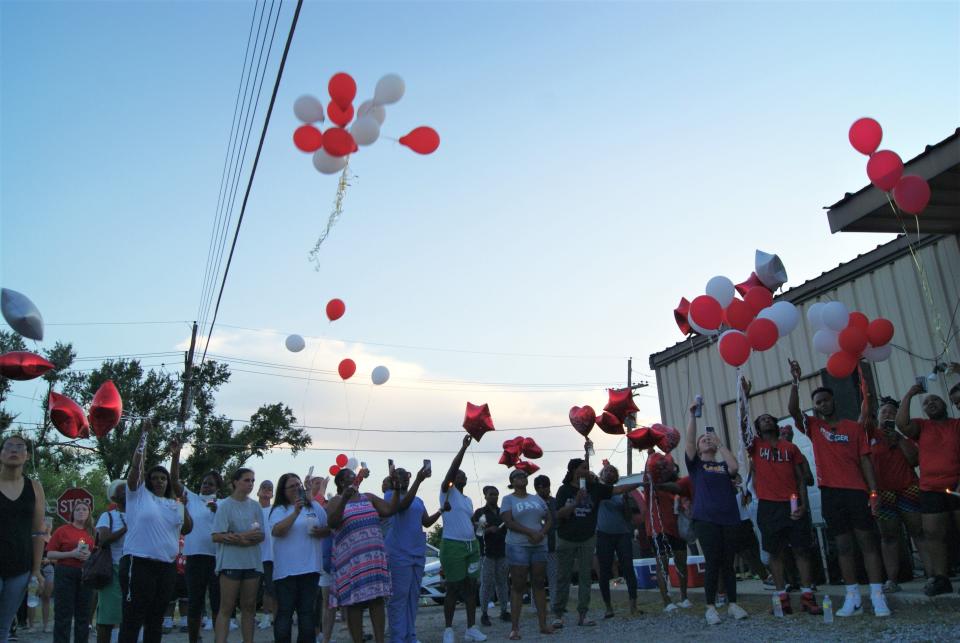 Friends, family and residents release balloons Wednesday night, June 22, 2022, during a candlelight vigil  in memory of 21-year-old Raceland resident Everette Jackson, who died during a rafting trip in Idaho last week.