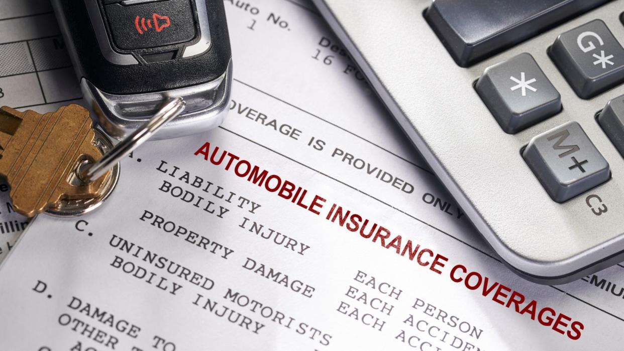 Auto and Car Insurance policy with keys and calculator.