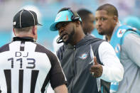 Miami Dolphins head coach Brian Flores, center, discusses a call with NFL down judge Danny Short (113), during the second half of an NFL football game, Sunday, Dec. 5, 2021, in Miami Gardens, Fla. (AP Photo/Wilfredo Lee)