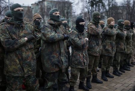 New volunteers for the Ukrainian Interior Ministry's Azov battalion line up before they depart to the frontlines in eastern Ukraine, in central Kiev January 17, 2015. REUTERS/Gleb Garanich