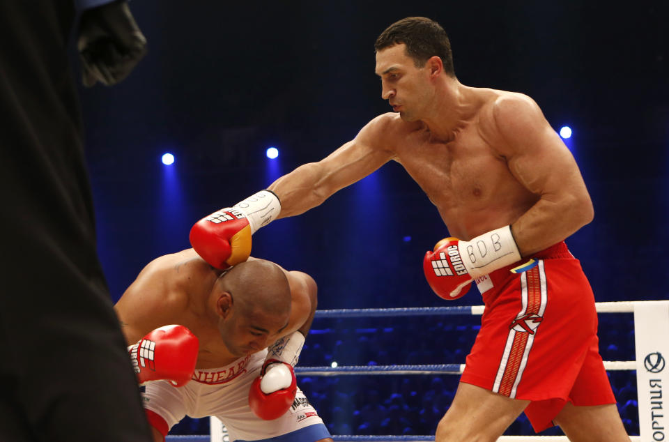 IBF, WBA, WBO and IBO champion Wladimir Klitschko from Ukraine, right, punches his Australian challenger Alex Leapai during their heavyweight world title bout in Oberhausen, western Germany, Saturday, April 26, 2014. (AP Photo/Frank Augstein)