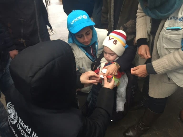 A picture from UNICEF on January 14, 2016 shows employees measuring the arm of a malnourished child in the besieged Syrian town of Madaya