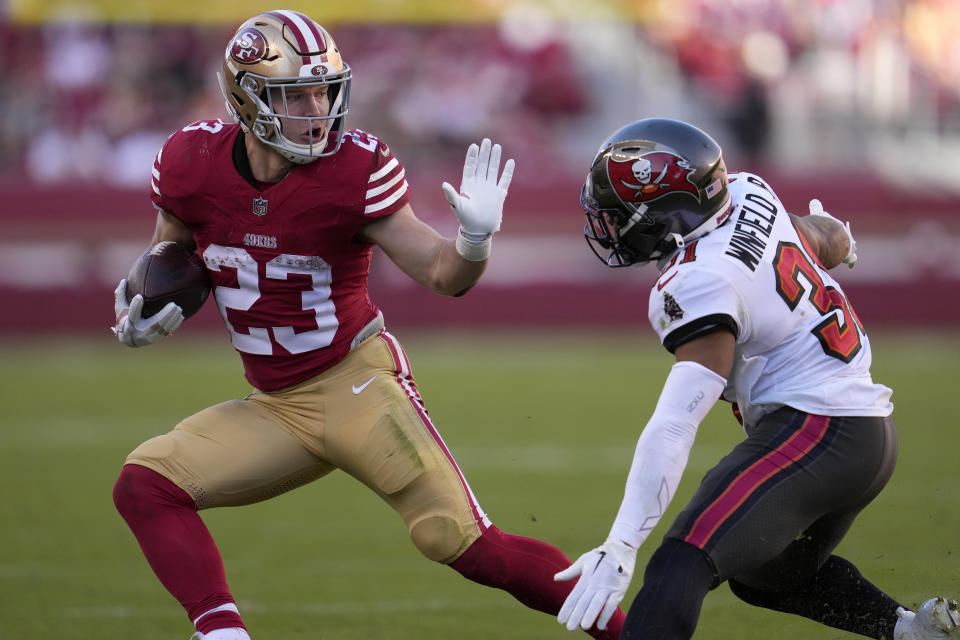 San Francisco 49ers running back Christian McCaffrey (23) runs against Tampa Bay Buccaneers safety Antoine Winfield Jr. (31) during the first half of an NFL football game in Santa Clara, Calif., Sunday, Nov. 19, 2023. (AP Photo/Godofredo A. Vásquez)